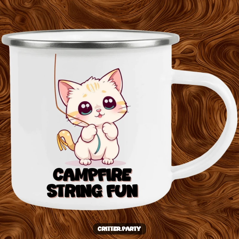 Funny camping mug featuring a small cat character playfully batting at a shiny, dangling streamer with wide eyes.