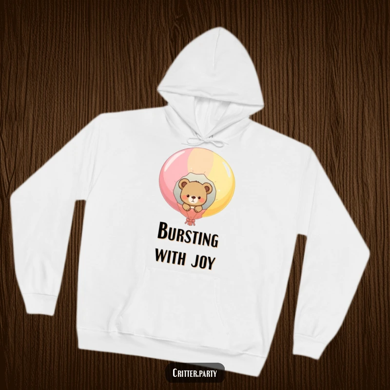 Funny hooded sweatshirt with a cute bear cub peeking from a popped balloon, soft and warm, perfect for cozy and humorous wear.